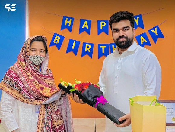 Team member receiving a birthday gift during the Team Birthdays event in 2024.