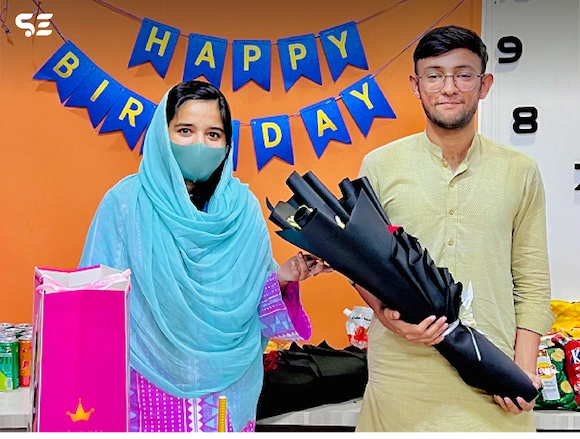 Team member receiving a birthday gift during the Team Birthdays event in 2024