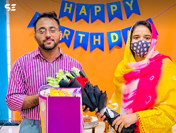 Team member receiving a birthday gift during the Team Birthdays event in 2024.