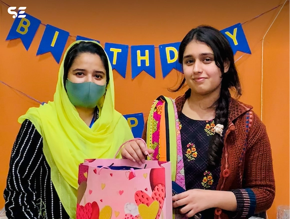 Team member receiving a birthday gift during the Team Birthdays event in 2024