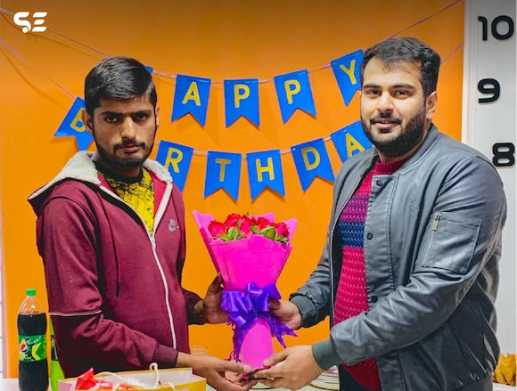 Team member receiving a birthday gift during the Team Birthdays event in 2024