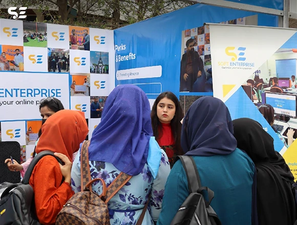 Visitors interacting with Soft Enterprise team at UOL Career Fair 2025.