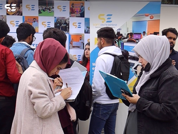 Soft Enterprise booth at UOL Career Fair 2025, with attendees engaging.