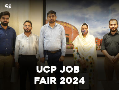 Team members of Soft Enterprise posing for a photo during the UCP Recruitment Drive 2024, with the University of Central Punjab in the background.