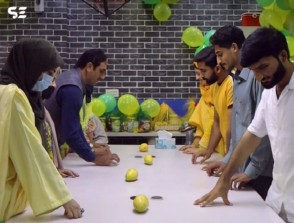 Colleagues enjoying fun games during Mango Day at office.