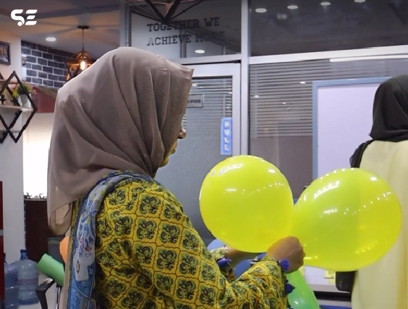Colleagues enjoying fun games during Mango Day at office.