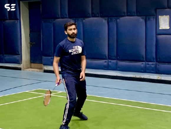Soft Enterprise employees playing badminton during Smash Day event.