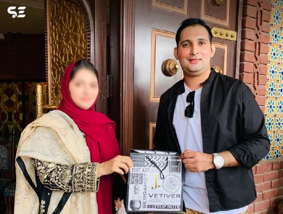 Soft Enterprise employee presenting a gift during farewell lunch.