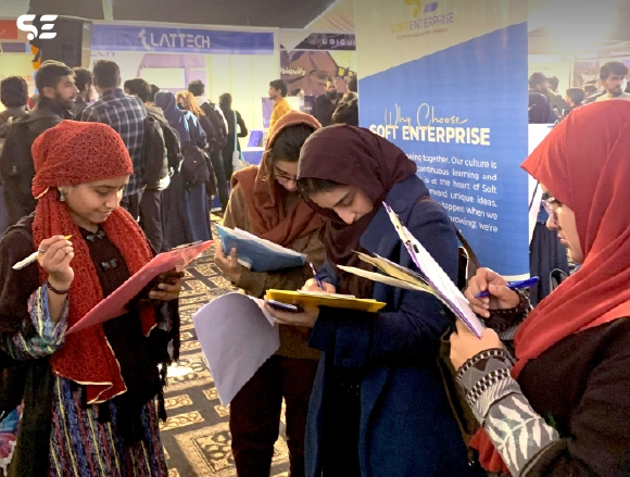 Attendees filling out forms at the Soft Enterprise event.