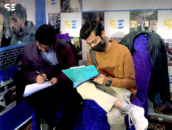 Attendees filling out forms at the Soft Enterprise event.