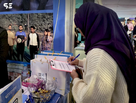Attendees filling out forms at the Soft Enterprise event.