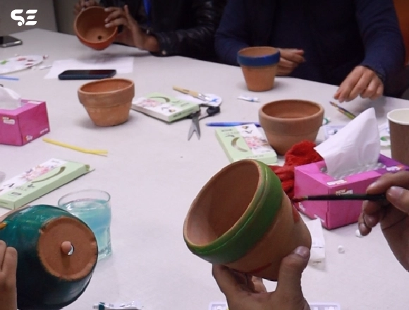 Soft Enterprise team collaborating in a painting game activity.