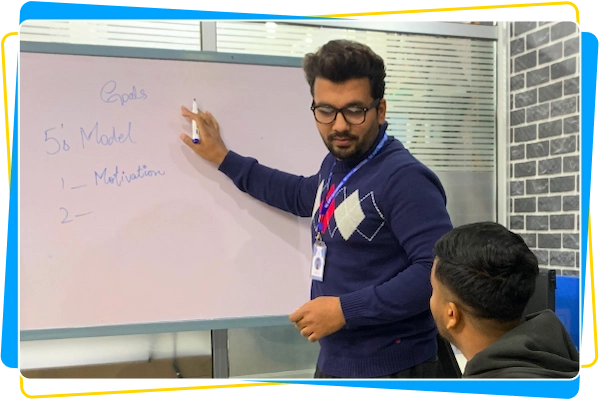 Project manager explaining software concepts on a whiteboard during a team discussion