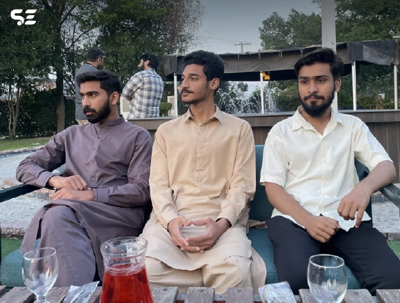 Group of male employees seated together at a gathering