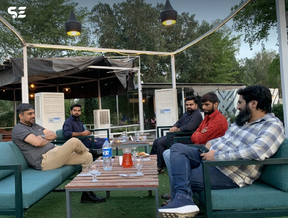 Colleagues relaxing together at an outdoor lounge area