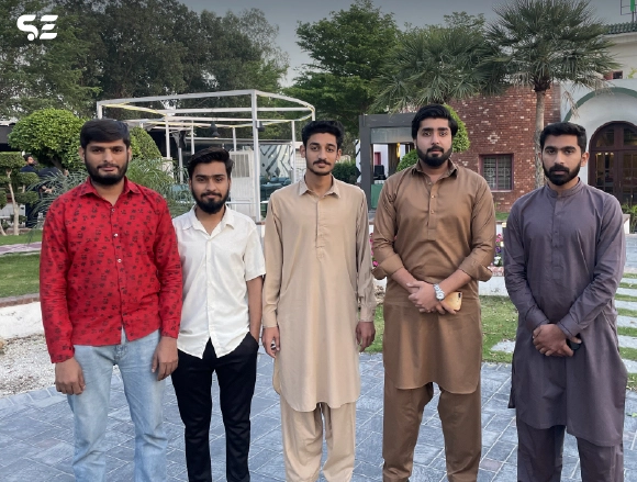 Group of male colleagues posing together outdoors