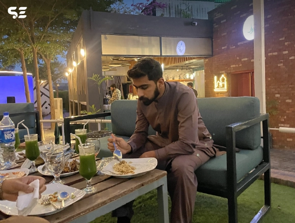 Male employee enjoying a meal at a restaurant table