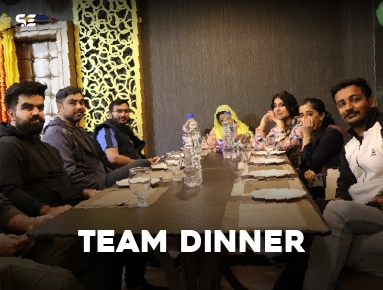 Team members seated together at a restaurant table for Team Dinner