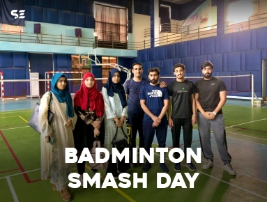 Team group photo holding a badminton racket for Badminton Smash Day