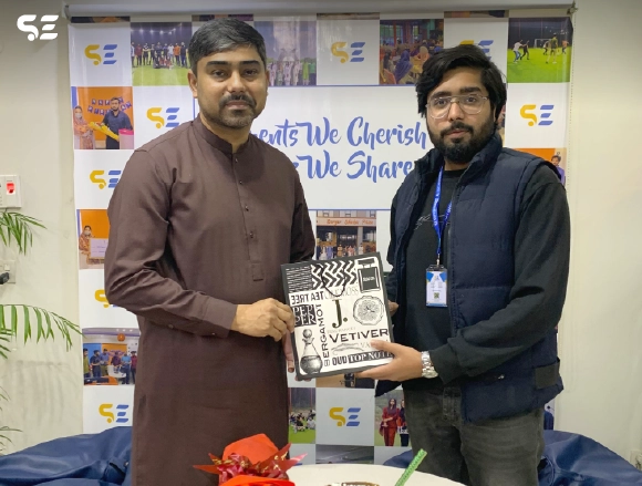 Two male employees holding a certificate of appreciation