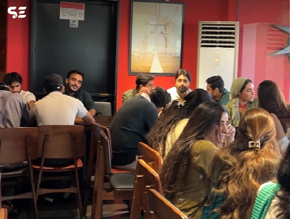 Group of male employees seated together at a table