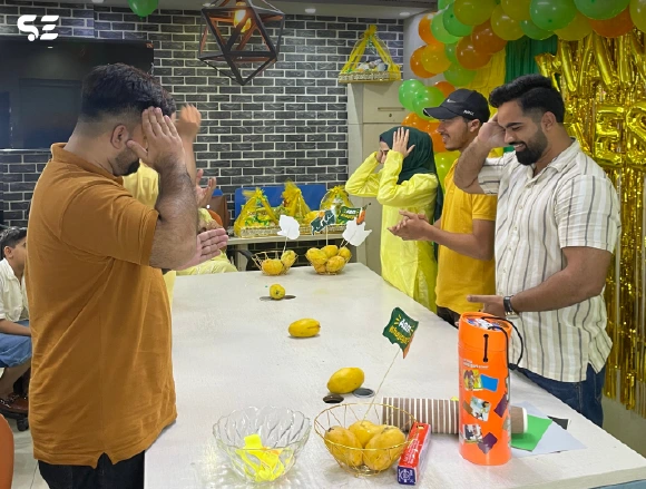 Team members preparing snacks on a table during mango event