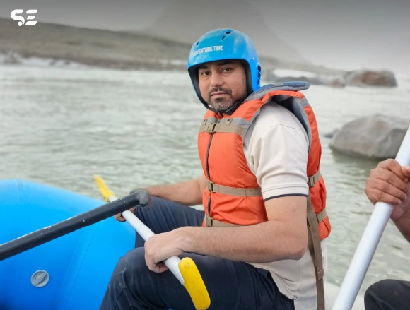 Man rowing a rafting boat down a river