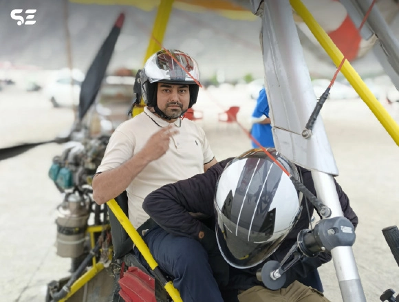 Man wearing a helmet posing before a paragliding flight