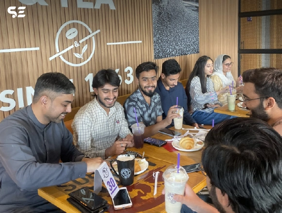 Group of employees seated together at a restaurant booth