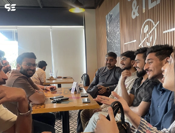 Group of male employees seated together at a restaurant table