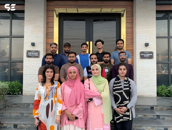 Soft Enterprise team group photo outside a restaurant entrance