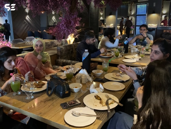 Group of colleagues having dinner together at a decorated restaurant table