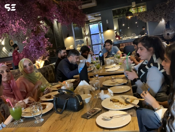 Team members having dinner together at a rustic-themed restaurant