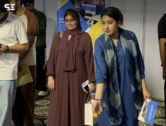 Two female employees in traditional dresses posing together