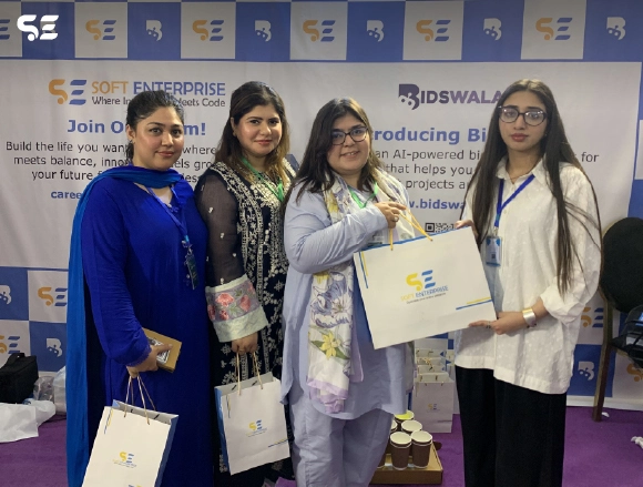Group of female employees posing with gift bags at Bidswala event