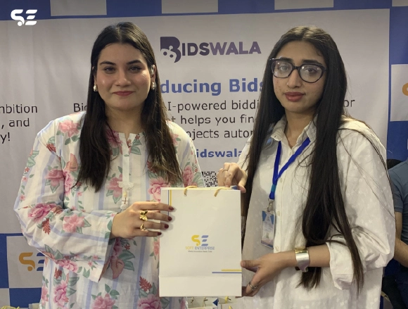 Female employee holding a gift envelope at Bidswala stall
